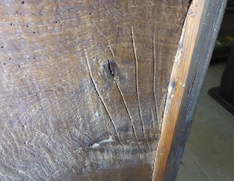 Possible carpenter's marks on the back of a pew