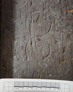South porch. Oak door. Compass-drawn circles.